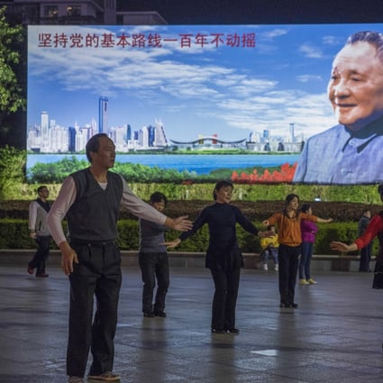 People exercise in front of a portrait of China’s former paramount leader, Deng Xiaoping, at a square in Futian district, Shenzhen – the city he designated as the nation’s first special economic zone 40 years ago. Photo: Sam Tsang