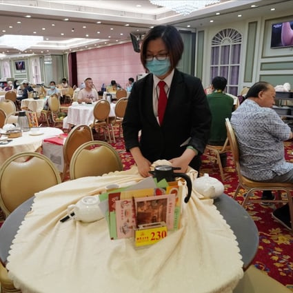 A staff member clears a table at a restaurant in Aberdeen on July 28. Some studies suggest social distancing at less than 2 metres can still be safe, raising hopes restaurants and other indoor venues can remain open for business during the pandemic. Photo: Felix Wong