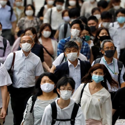 Commuters and passers-by wearing protective face masks in Tokyo. Photo: Reuters