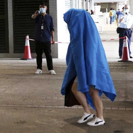 The woman walked into Pamela Youde Nethersole Eastern Hospital in Chai Wan on Friday morning, covering her head with a blue towel. Photo: Handout