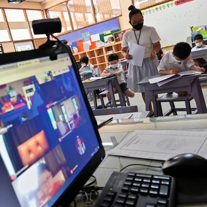 A teacher at an international school in Bangkok attends to students both in the classroom and online after reopening in June amid the coronavirus pandemic. Photo: AFP