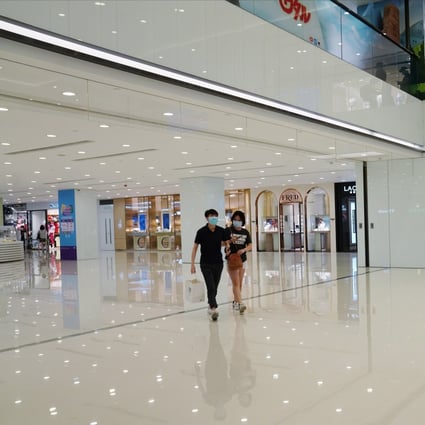 Shoppers on face masks walk through a virtually deserted Harbour City shopping mall in Tsim Sha Tsui. Photo: Sam Tsang