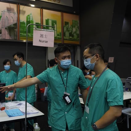 Medical workers make preparations at a temporary field hospital set up at AsiaWorld-Expo on August 1, as Hong Kong recorded more than a week of triple-digit highs in Covid-19 infections. Photo: AP