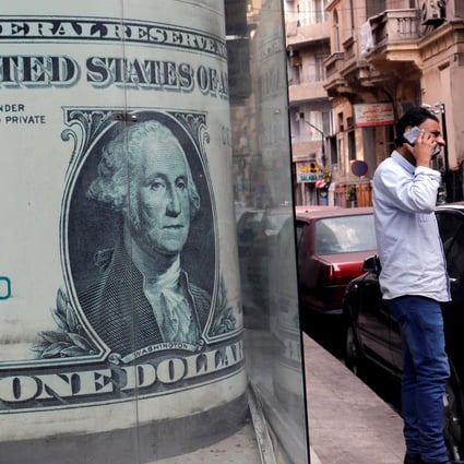 An image of a US dollar bill at a currency exchange bureau in Cairo. The dollar is losing its lustre against gold, silver and other key currencies. Photo: Reuters