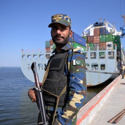 A member of the Pakistani navy guards a ship carrying containers at the Gwadar port in 2016. Photo: AFP