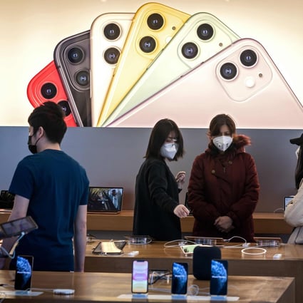 Apple staff and customers are seen in a store in Beijing on February 22. Photo: AFP