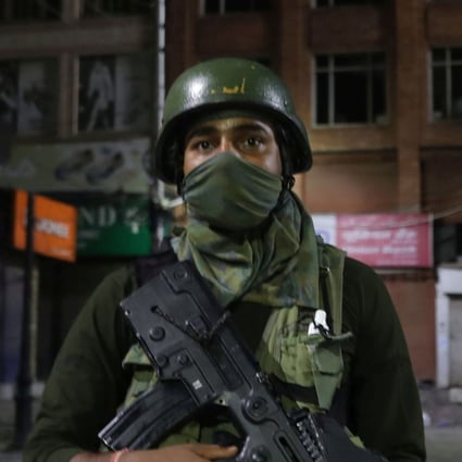 An Indian paramilitary soldier guards near a closed market during lockdown in Srinagar, Kashmir on Monday. Photo: EPA-EFE