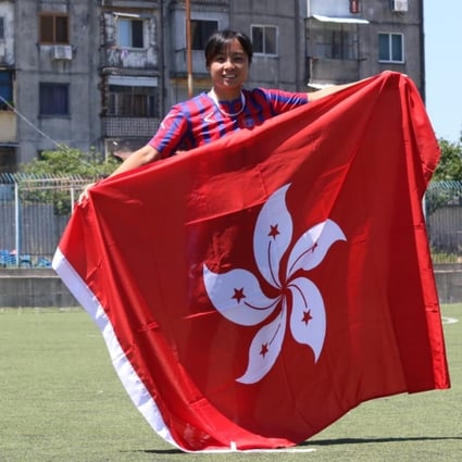 Hong Kong national team player Wai Yuen-ting poses with the Hong Kong flag in Shkoder, Albania. Photo: Graeme Chan
