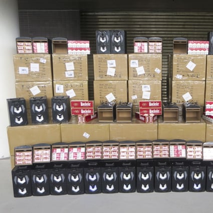 Customs authorities display some HK$1.7 million worth of contraband cigarettes found concealed in hi-fi speakers on Tuesday. Photo: Handout