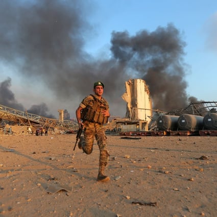 A Lebanese army soldier runs at the scene of the explosion at the port of Lebanon's capital Beirut. Photo: AFP
