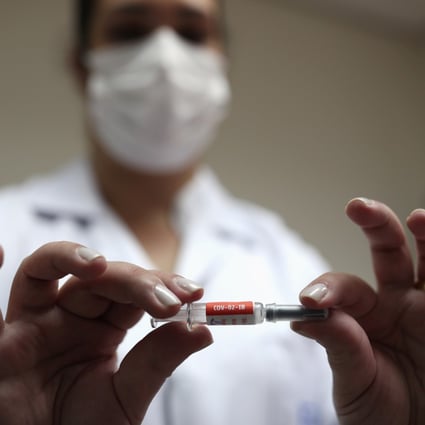 A nurse holds a potential vaccine from China’s SinoVac before administering it during trials in Brazil. Photo: Reuters