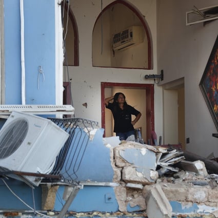 A woman stands inside a damaged restaurant a day after an explosion ripped through the seaport of Beirut, Lebanon. Photo: AP