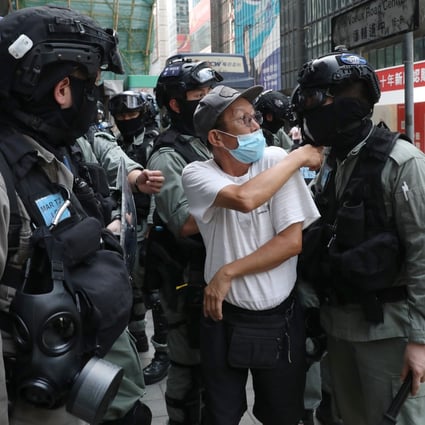 A spectator argues with riot police after being told to step further away during an anti-government demonstration in the financial district of Central on May 27. Photo: Nora Tam
