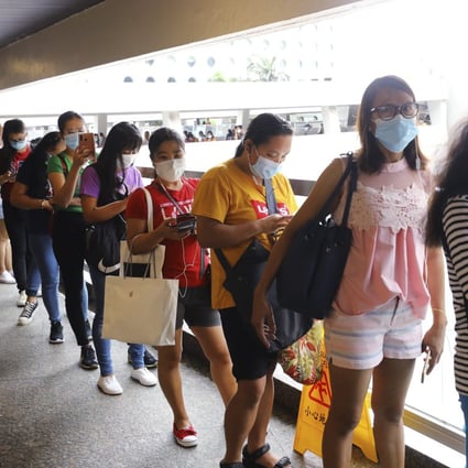 Foreign domestic helpers queue up to transfer money at World Wide House in Central earlier this month. Photo: Dickson Lee