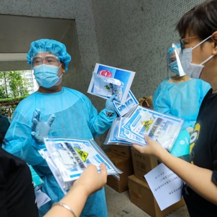 Medical staff give out testing kits to residents in Ping Shek Estate in Kwun Tong. Photo: Dickson Lee