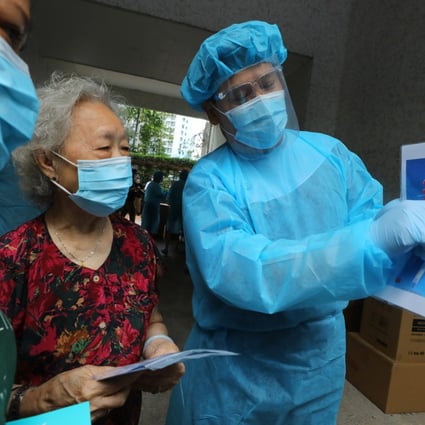 Hong Kong medical workers instruct city residents on how to use Covid-19 testing kits. The government on Friday announced a massive new programme that will allow for voluntary coronavirus testing beginning in two weeks. Photo: Dickson Lee