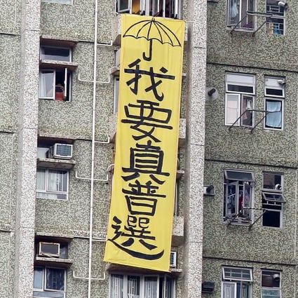A banner saying: “I want universal suffrage”, hangs by the side of a block of flats in Tseung Kwan O in May 2016, during a visit to Hong Kong by a top mainland official. Photo: Nora Tam