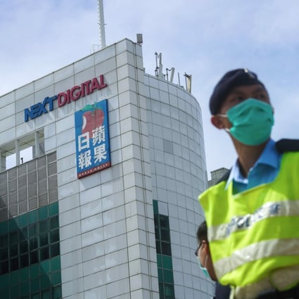 A police officers outside the Next Digital building in Tseung Kwan O on Monday morning. Photo: Winson Wong