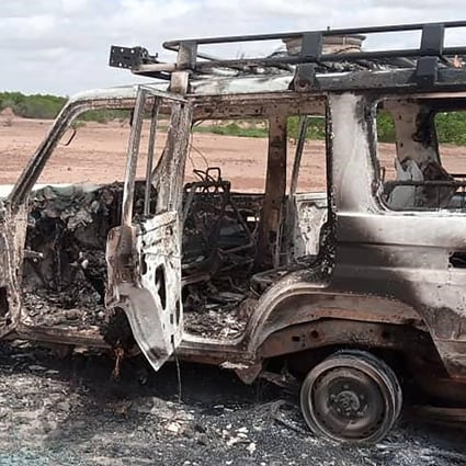 The burnt-out remains of a 4x4 vehicle with bullet holes in the side. Photo: AFP