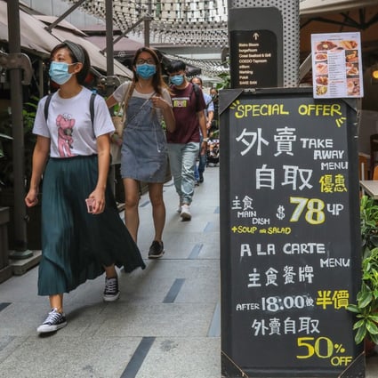 People walk past a restaurant in Causeway Bay on Monday. Photo: Nora Tam
