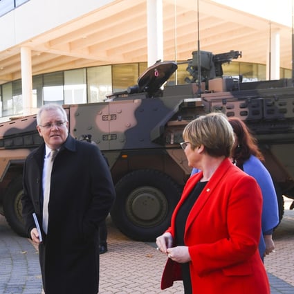 Australian Prime Minister Scott Morrison and Defence Minister Linda Reynolds walk past an armoured combat vehicle as they arrive at the Australian Defence Force Academy in Canberra on July 1. Morrison has pledged to spend billions on defence over the next 10 years in a move widely seen as aimed at countering China’s growing presence in the region. Photo: EPA