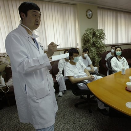Dr Joseph Sung, then chairman of the Prince of Wales Hospital’s department of medicine and therapeutic, conducts a daily meeting with medical staff during the height of 2003’s Sars epidemic. Photo: SCMP