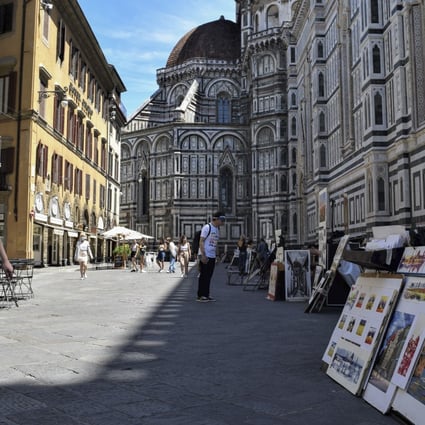Picture sellers on another quiet day outside the Duomo di Firenze, in Florence, Italy. Photo: Red Door News