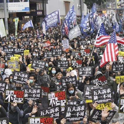 Tens of thousands of anti-government protesters march in central Hong Kong on January 1 as they continue to pressure the government to meet their five demands, including greater democracy, amnesty for arrested protesters and an independent inquiry into police use of force. Photo: Kyodo