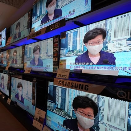 Screens at an electronic store in Taikoo Shing broadcast a press conference by Hong Kong Chief Executive Carrie Lam Cheng Yuet-ngor on July 31, announcing the postponement of the September 6 Legislative Council election for a year over a fresh Covid-19 wave in the city. Photo: Felix Wong