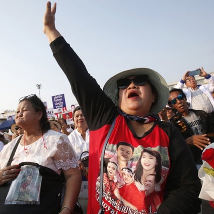 A Pheu Thai Party supporter wears a T-shirt bearing the likeness of former prime ministers Thaksin and Yingluck Shinawatra. Photo: AP