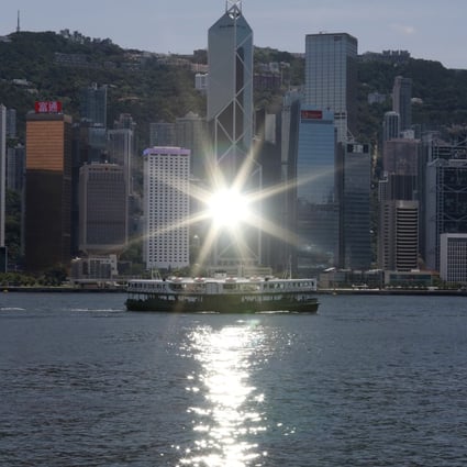 Sunlight reflects off the Bank of China building in Central, as a Star Ferry crosses Victoria Harbour in Hong Kong. Some mainland companies listed in the US are considering secondary listings in Hong Kong. Photo: Nora Tam