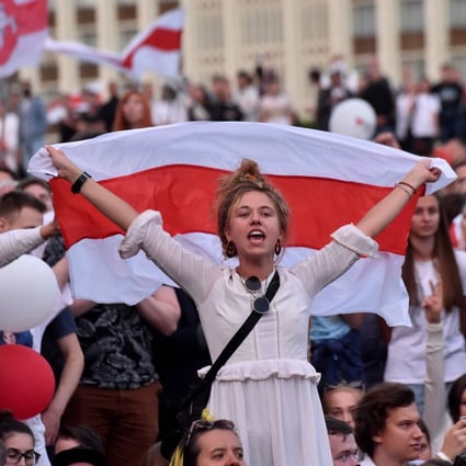 A woman holds a Belarus flag during a protest rally against police violence in central Minsk on August 14, 2020. Photo: AFP
