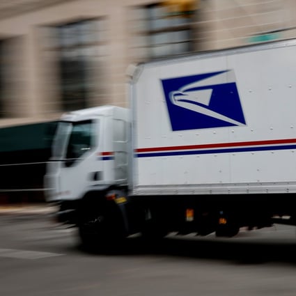 A US Postal Service mail truck drives through midtown Manhattan in New York on Thursday. Photo: Reuters