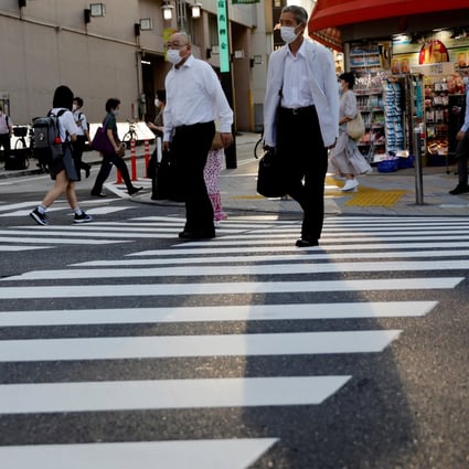 Pedestrians cross a road in Tokyo. The Japanese economy contracted at a record pace between April and June as Covid-19 restrictions curbed consumer spending. Photo: Reuters