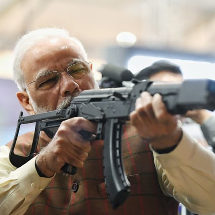 Indian Prime Minister Narendra Modi holds a rifle during a defence expo in February. The country is looking to import military equipment amid tensions with its neighbours, despite plans to boost its own defence industry. Photo: AP