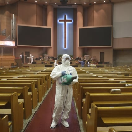Public officials disinfect a church in South Korea. Photo: AP