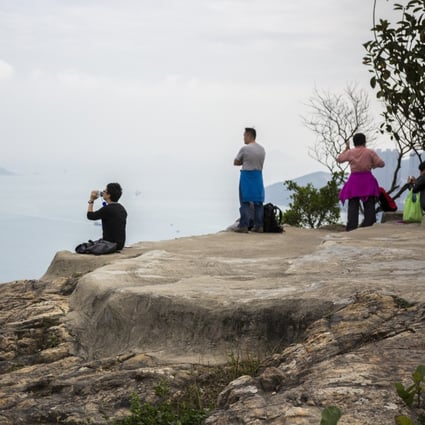 Hikers overlook Tseung Kwan O from Devil’s Peak, near where police issue fines for lack of masks. Photo: Christopher DeWolf