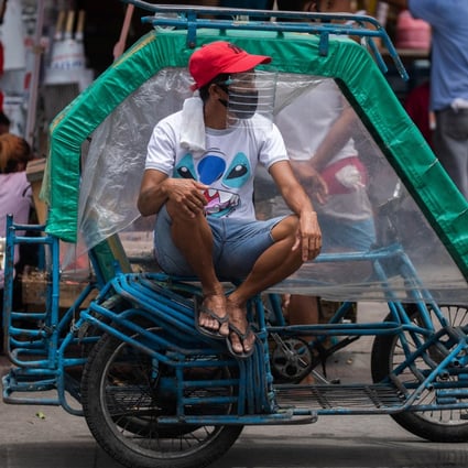 A rickshaw driver wears a face mask and a makeshift face shield made of a water bottle, following their mandatory use in all public transport, amid the coronavirus outbreak in Manila, Philippines. The worst impacts of the pandemic have been felt by informal workers, migrant workers and the poor. Photo: Reuters