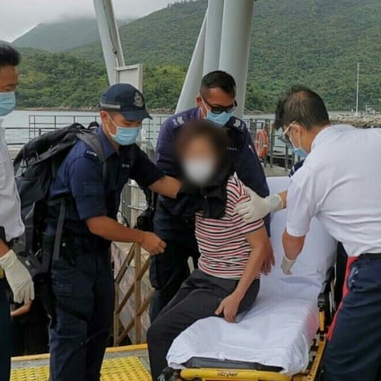 Rescuers helping the elderly woman after she was taken to shore in Sai Kung. Photo: Handout