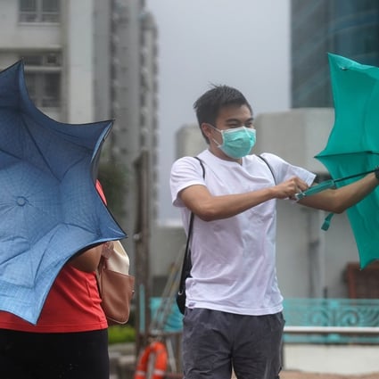 Pedestrians struggle with their umbrellas as storm Higos closes in on Hong Kong. Photo: Winson Wong