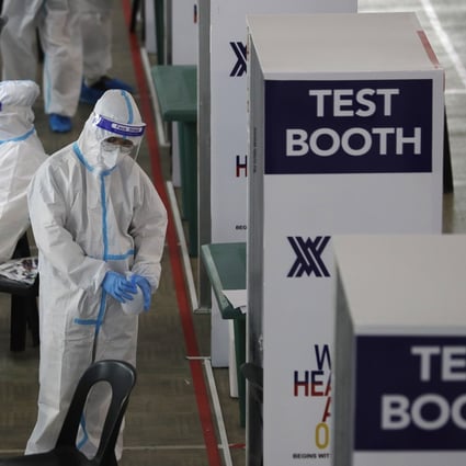 Health workers are seen at a Covid-19 testing centre in Manila. Former employees say there has been massive corruption at the state health insurance agency, PhilHealth, including overpaying for testing kits. Photo: AP