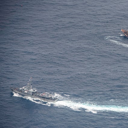 An Ecuadorean navy vessel circles a fishing boat after detecting a fleet of mostly Chinese-flagged ships this month. Photo: Reuters