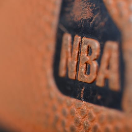 The NBA logo is seen on the ball during a game between the Orlando Magic and the Denver Nuggets. Photo: AFP