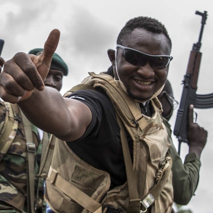 A Malian soldier gives the thumbs up as civilians cheer for troops and police driving through the streets of Bamako on Wednesday. Photo: EPA-EFE