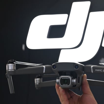 An employee shows the Mavic Pro 2 drone in a DJI store in Shanghai on May 22, 2019. Photo: AFP