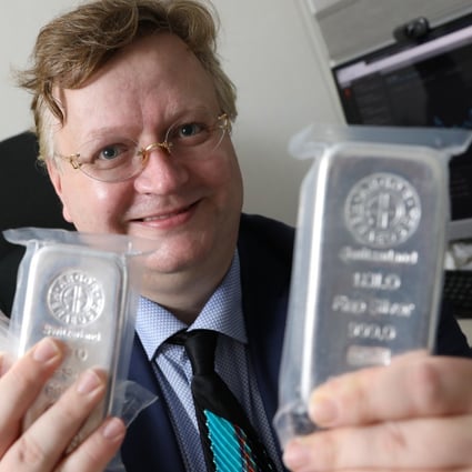 Pádraig Seif, partner of Precious Metal Asia, holds silver bars in his office in Sheung Wan. He reports a surge in buying interest in silver. Photo: May Tse