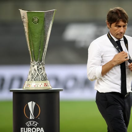 Inter Milan coach Antonio Conte walks past the Uefa Europa League trophy after the final. Photo: Xinhua