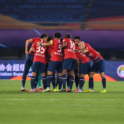 Chongqing Dangdai Lifan players ready themselves for kick-off ahead of meeting Shijiazhuang Ever Bright. Photo: Xinhua