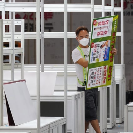 A worker takes down a booth after the Hong Kong Book Fair was cancelled. Photo: Sam Tsang