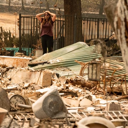 Alyssa Medina examines the charred remains of her family home in Vacaville, California. Photo: AFP